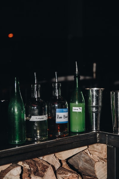 Green glass bottles brown wooden table
